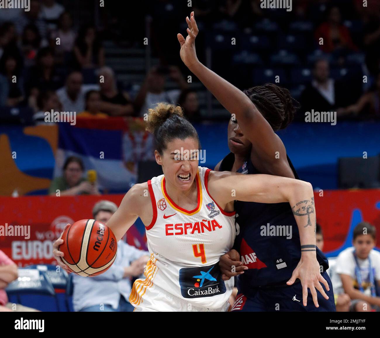 Spain's Laura Nicholls, left, drives to the basket as France's Endene Miyem  tries to block her during the Women's 2019 Eurobasket European Basketball  Championship final match between Spain and France in Belgrade,