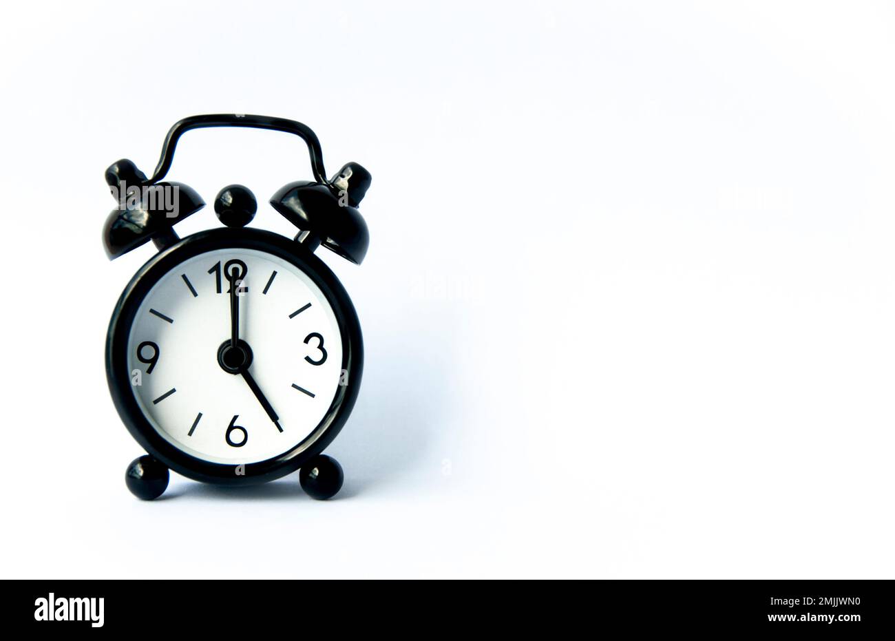 Black Alarm Clock Pointing At 5 O clock With Customizable Space For black-alarm-clock-pointing-at-5-o-clock-with-customizable-space-for