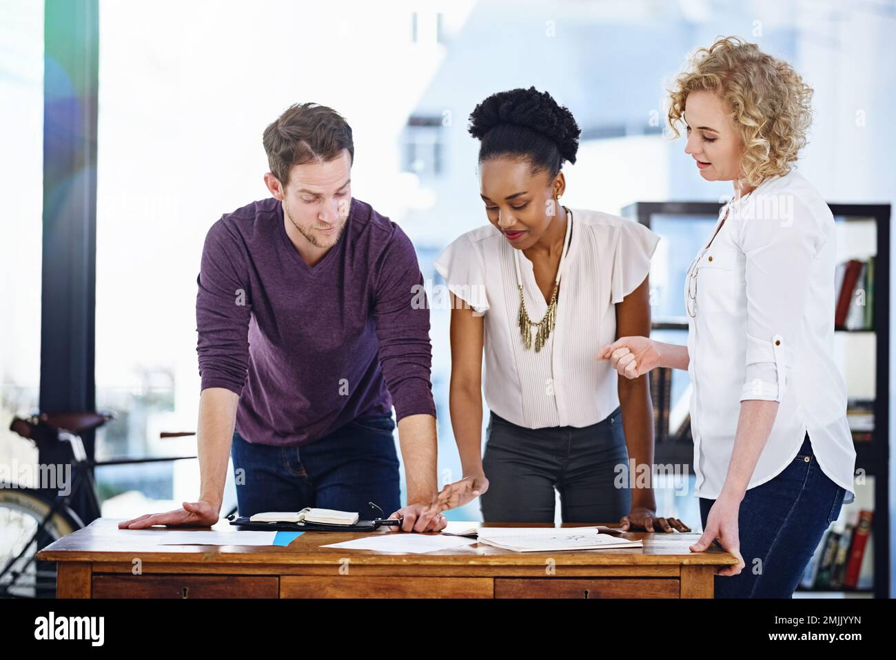 Aligning their vision to match success. a team of designers working together in the office. Stock Photo