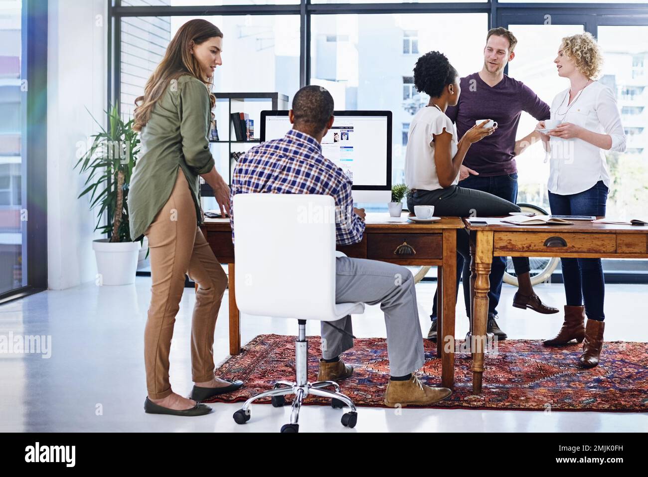 Its a casual but productive workplace. a team of designers working together in the office. Stock Photo