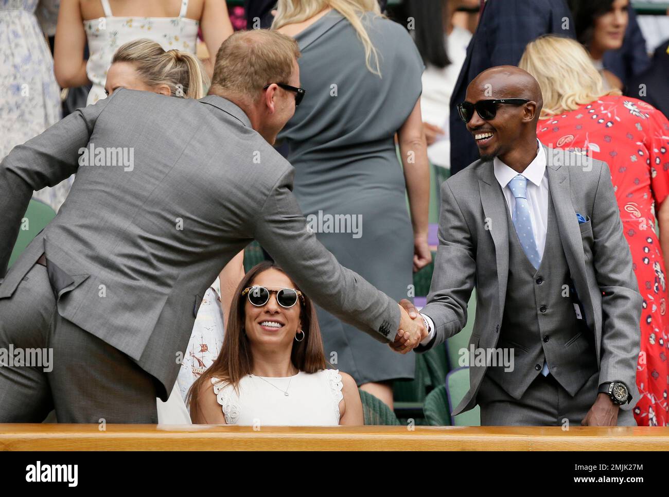 athlete-sir-mo-farah-right-shakes-hands-with-former-cyclist-sir-chris-hoy-as-they-arrive-in-the-royal-box-on-centre-court-during-day-six-of-the-wimbledon-tennis-championships-in-london-saturday-july-6-2019-ap-phototim-ireland-2MJK27M.jpg