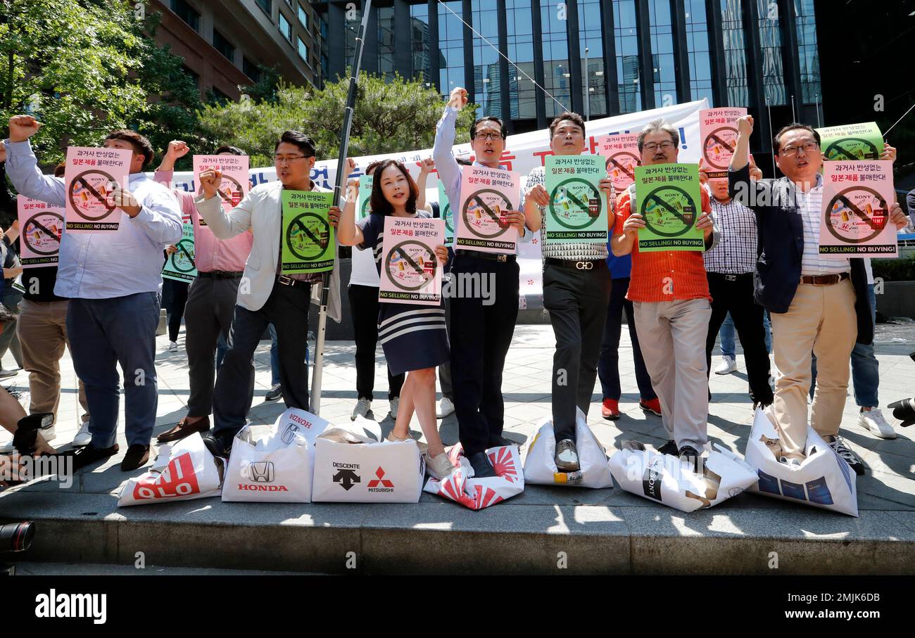 South Korean merchants shout slogans as they trample boxes symboling ...