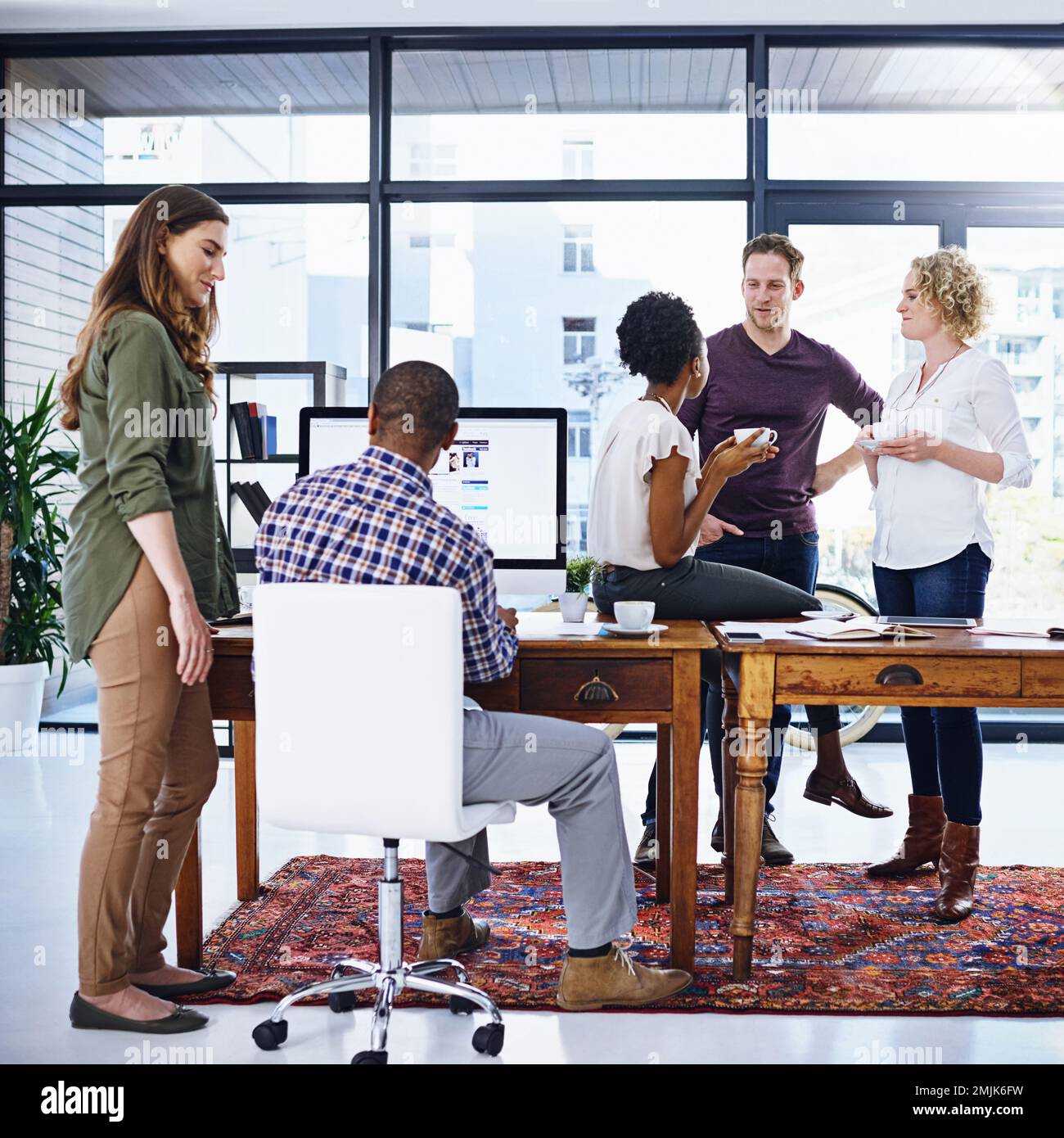 Theyve got the project covered. a team of designers working together in the office. Stock Photo