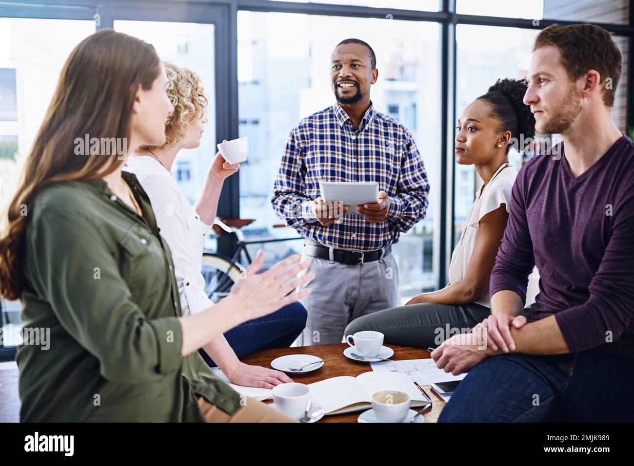 Collaboration is the surest way to success. a team of designers working together in the office. Stock Photo