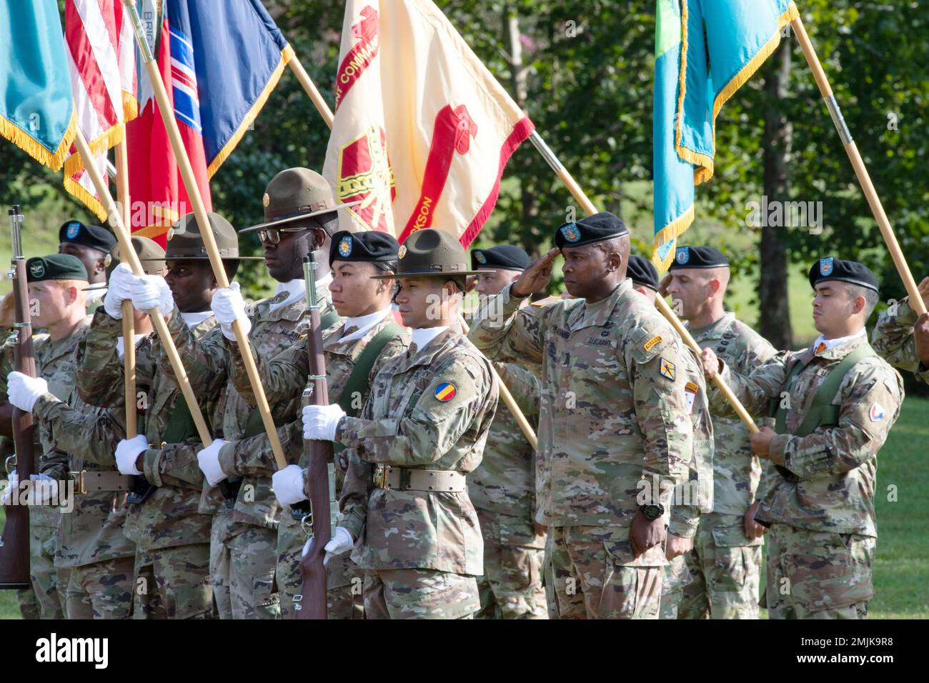 Post Command Sgt. Maj. Philson Tavernier, middle right, salutes during