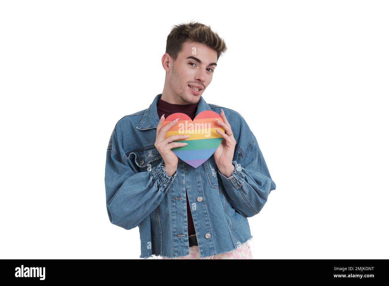 Young caucasian man smiling at camera with lgbt flag heart, isolated. Stock Photo