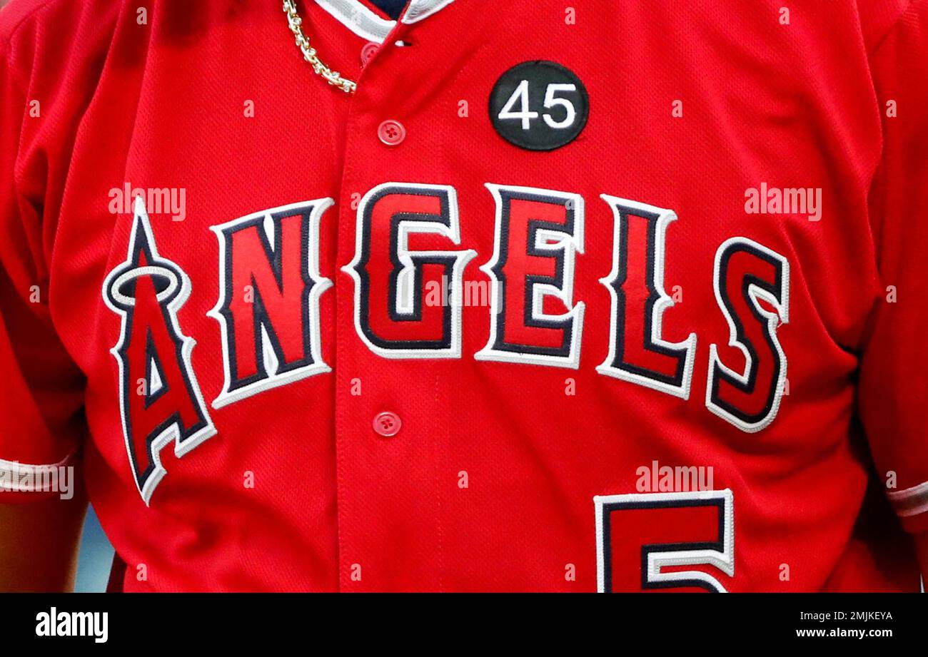A black patch with the number 45 honoring Tyler Skaggs is seen on the jersey  of Albert Pujols during an at-bat in the first inning of a baseball game  against the Texas