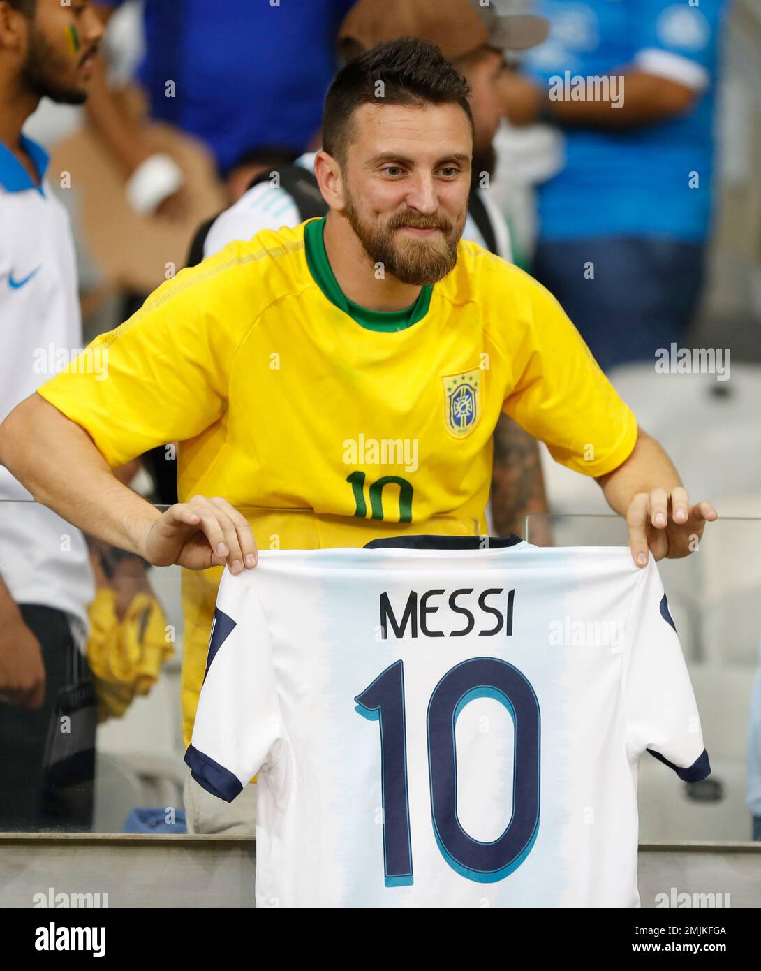 A fan shows a photo and a team jersey of Brazilian football star Ronaldo  Luis Nazario de Lima, commonly known as Ronaldo, to welcome him at the Hong  K Stock Photo 