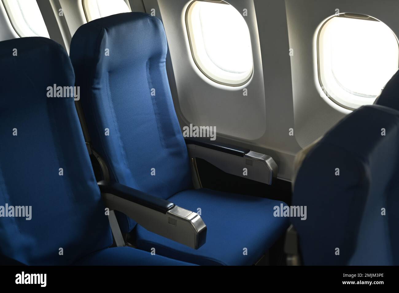 Airplane cabin interior, empty comfortable seats in economy class with ...