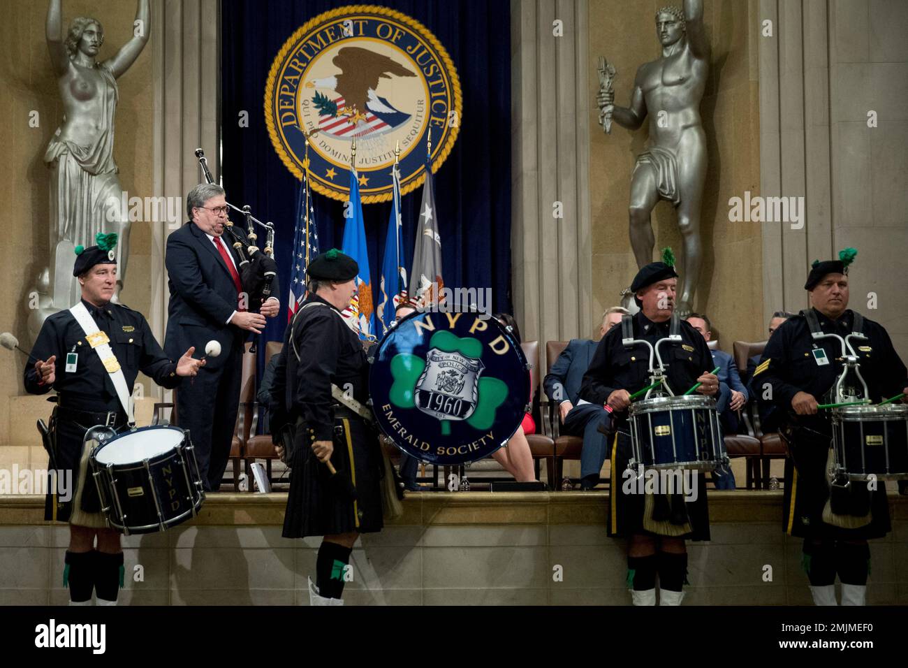 Attorney General William Barr, second from left, surprises the audience