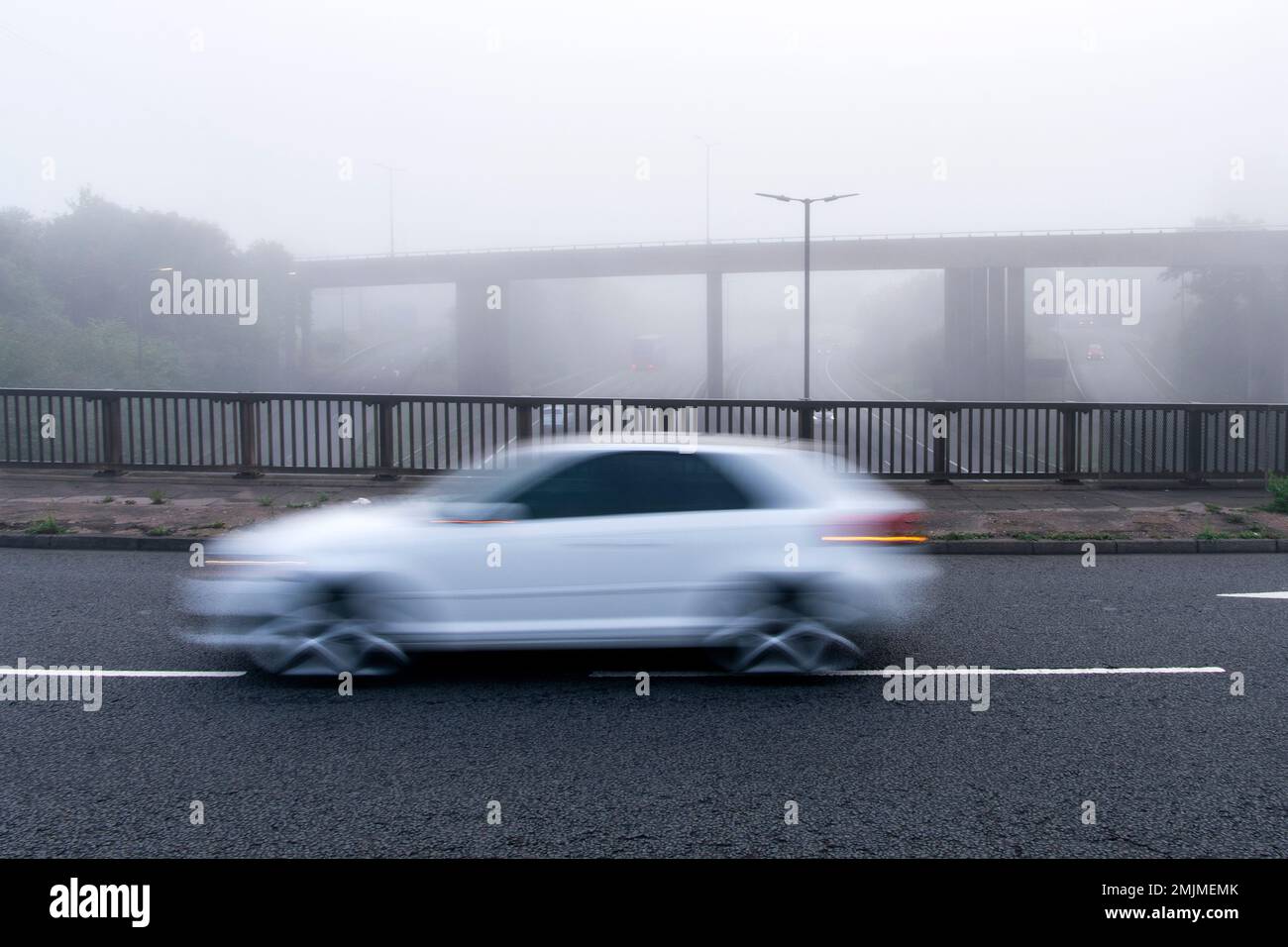 Car speeding past on a motorway roundabout Stock Photo Alamy