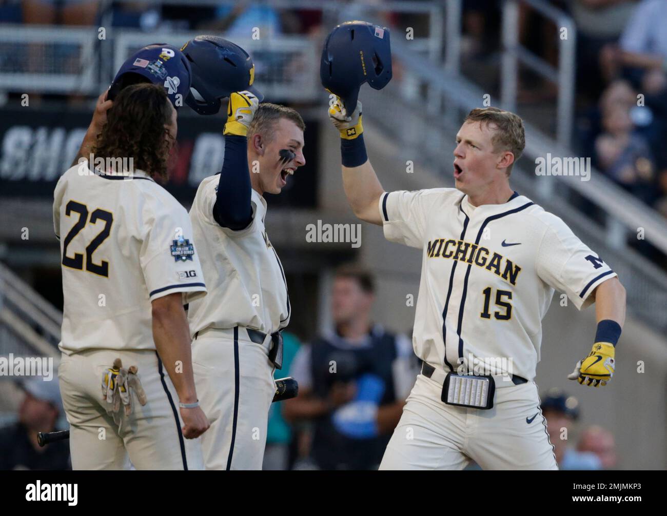 Michigan's Jimmy Kerr, right, celebrates after hitting a 2-run home run