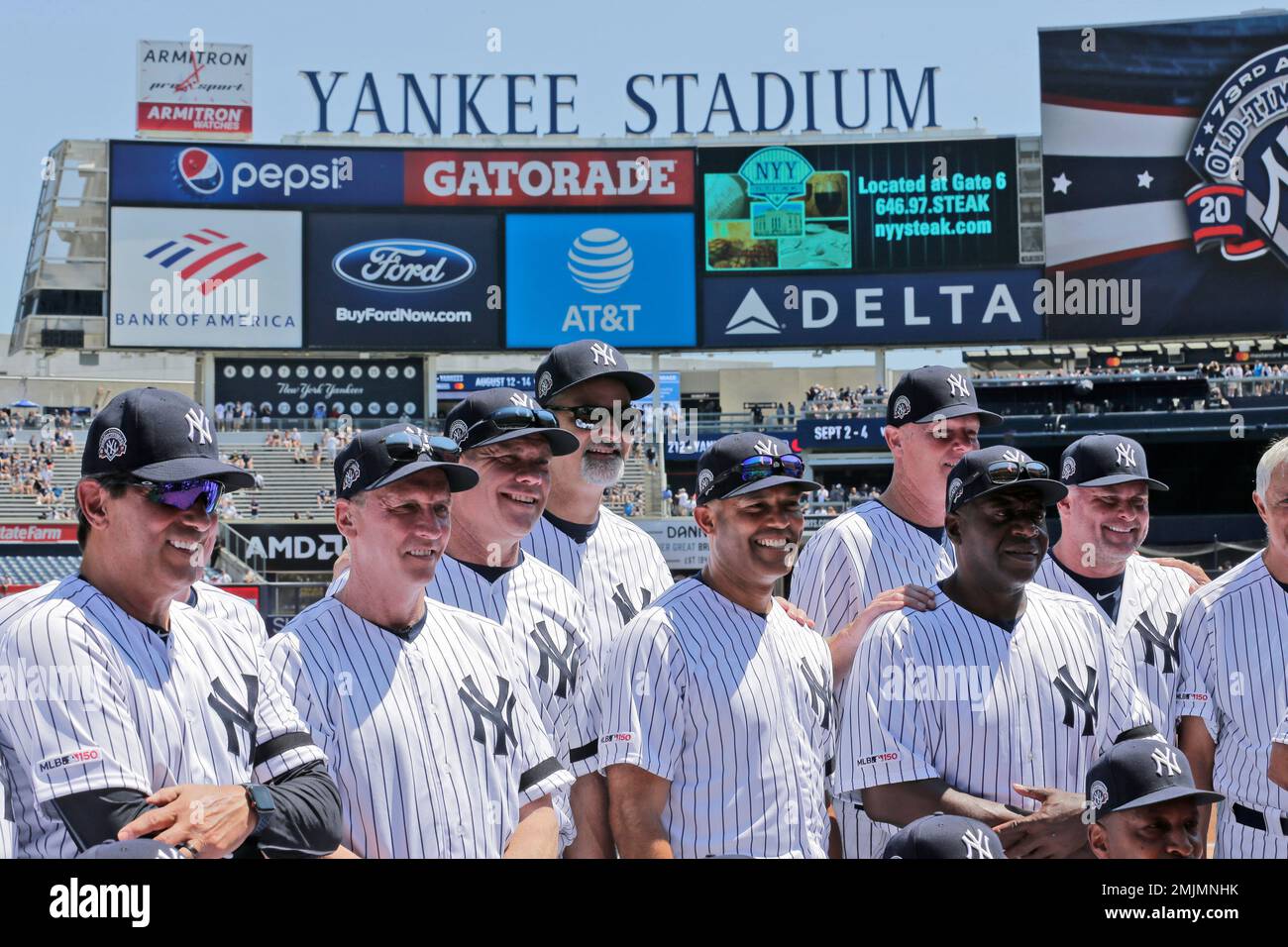 Former New York Yankees players, including Mariano Rivera, center, pose