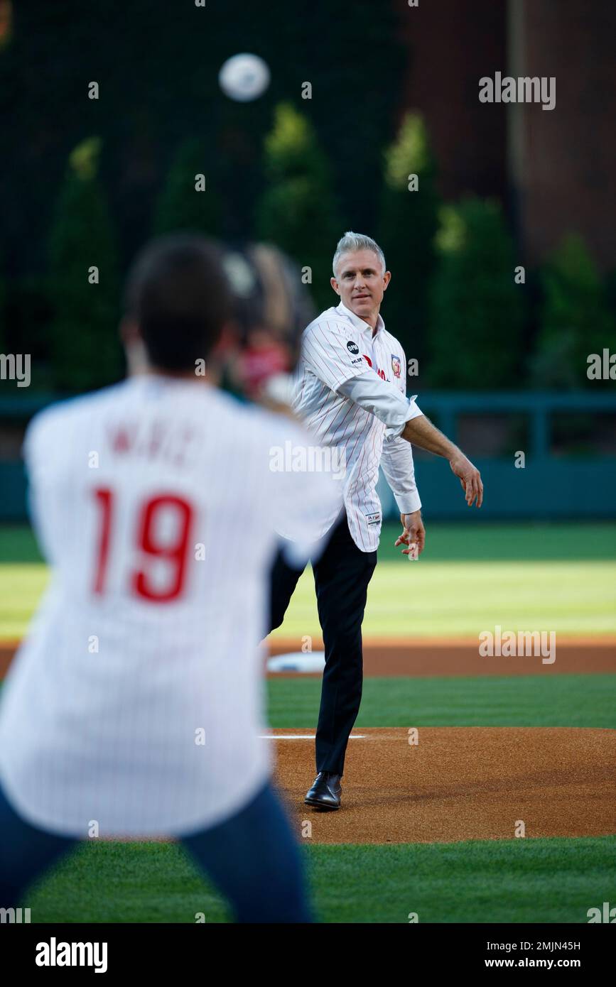 Former Philadelphia Phillies' Chase Utley, right, throws a ceremonial first  pitch to actor Rob McElhenney, creator of It's Always Sunny in  Philadelphia before a baseball game between the Philadelphia Phillies and  the
