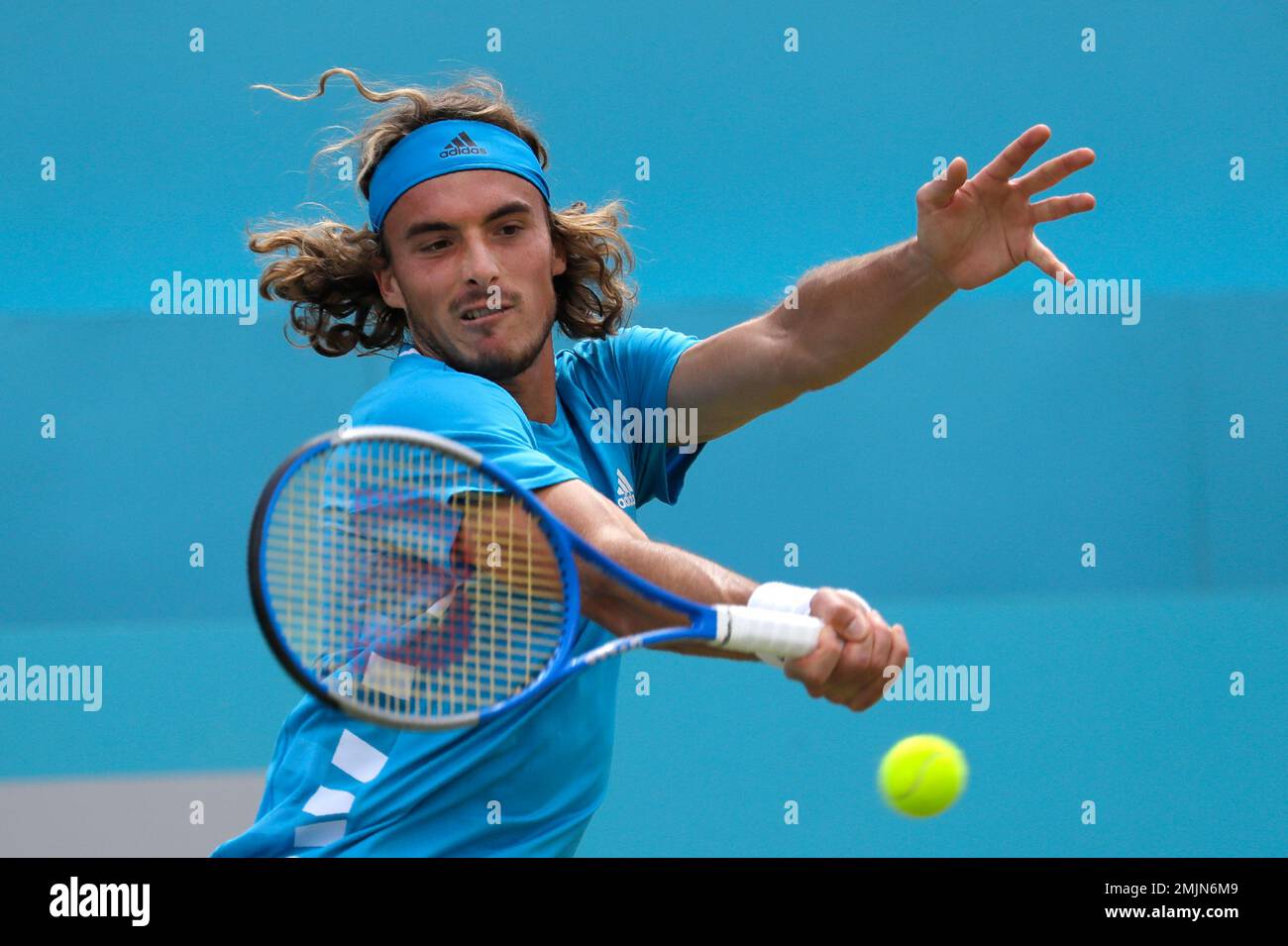 Stefanos Tsitsipas of Greece plays a return to Felix Auger-Aliassime of Canada during their quarterfinal singles match at the Queens Club tennis tournament in London, Friday, June 21, 2019