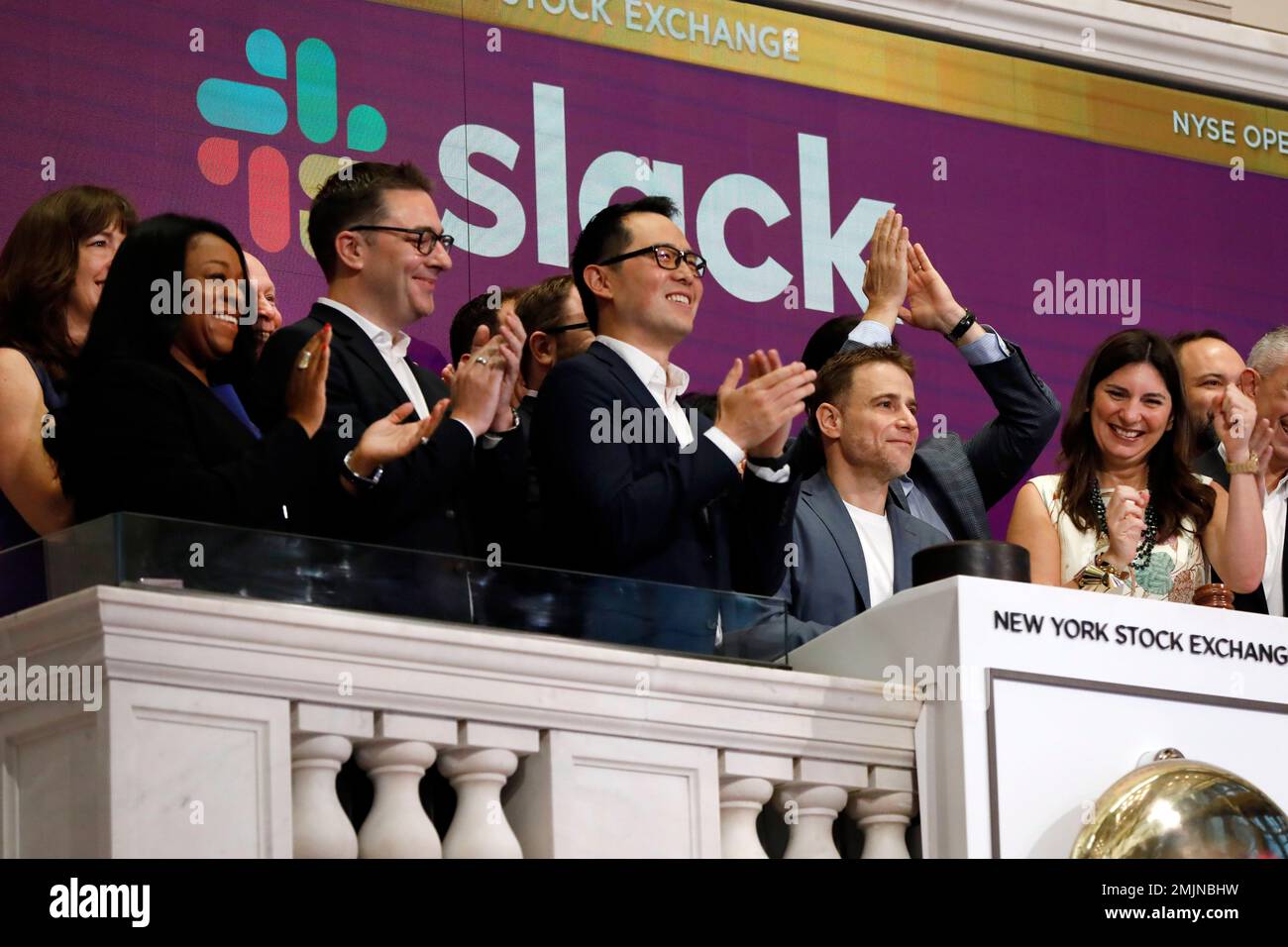 Slack CEO Stewart Butterfield, second from right, is applauded as he
