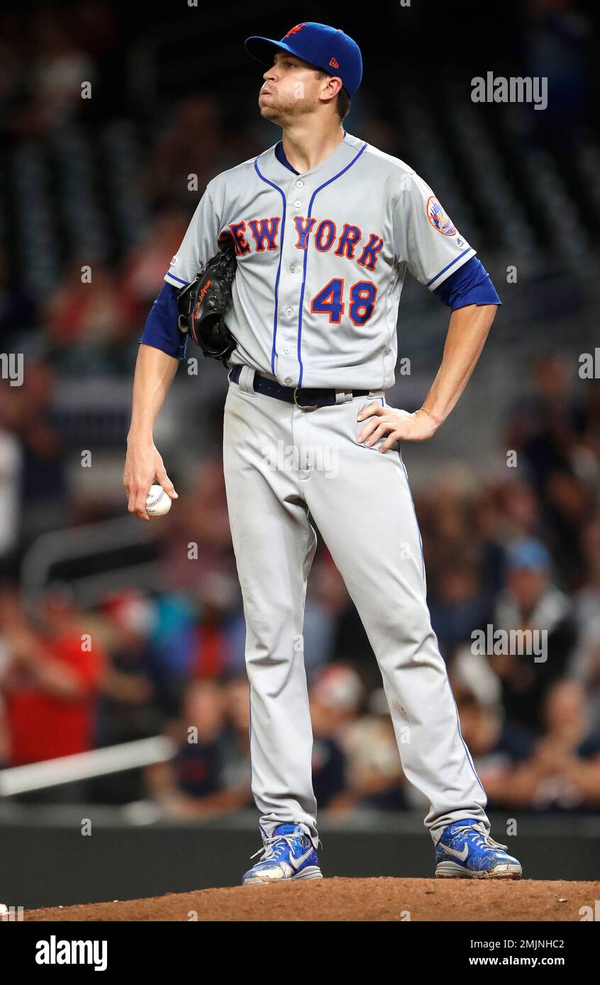 New York Mets starting pitcher Jacob deGrom (48) looks up at the scoreboard  after losing his bid for a shutout on a home run by Atlanta Braves' Freddie  Freeman in the ninth