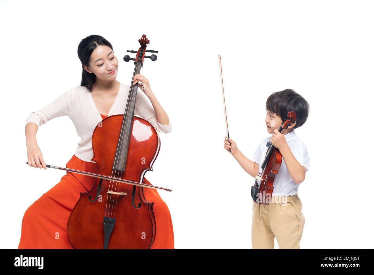 The female teacher guide the boy playing Musical Instruments Stock Photo