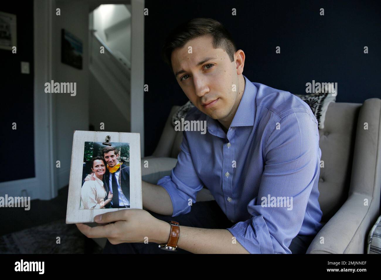 Dane Shikman holds a photograph showing him with his mother, Elizabeth ...