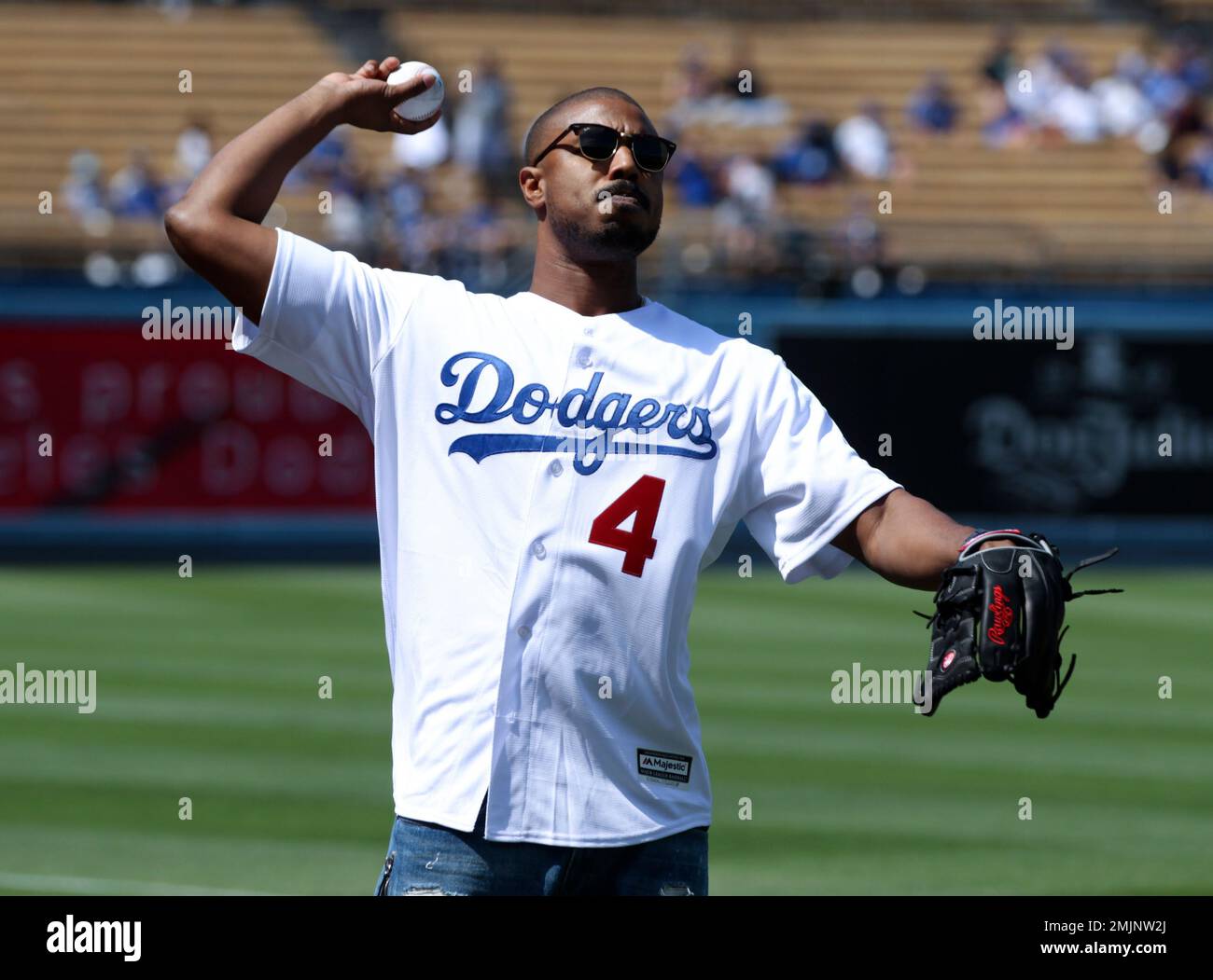 Actor Michael B. Jordan warms up on the sidelines before a