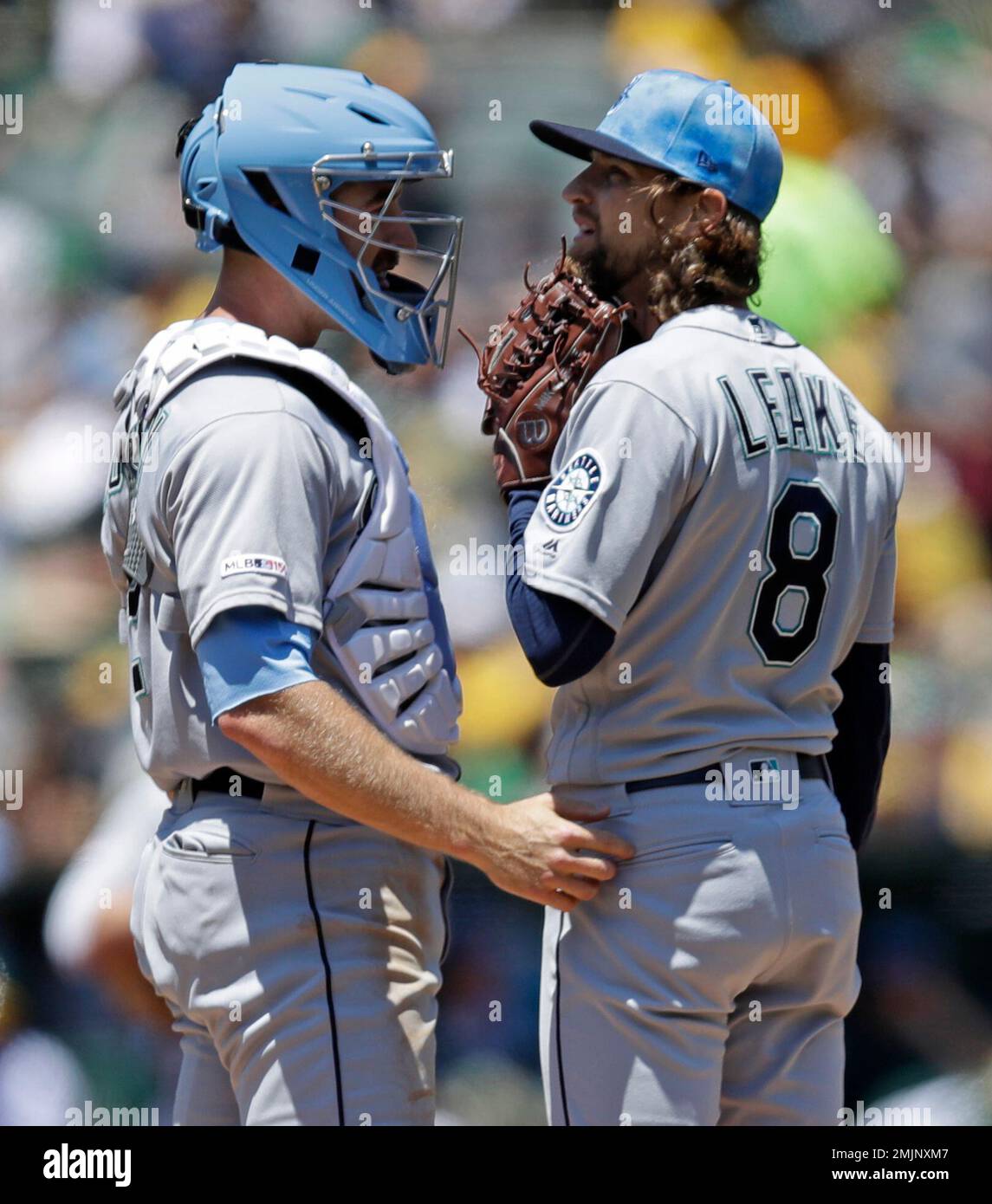 Seattle Mariners catcher Tom Murphy, left, speaks with pitcher Mike