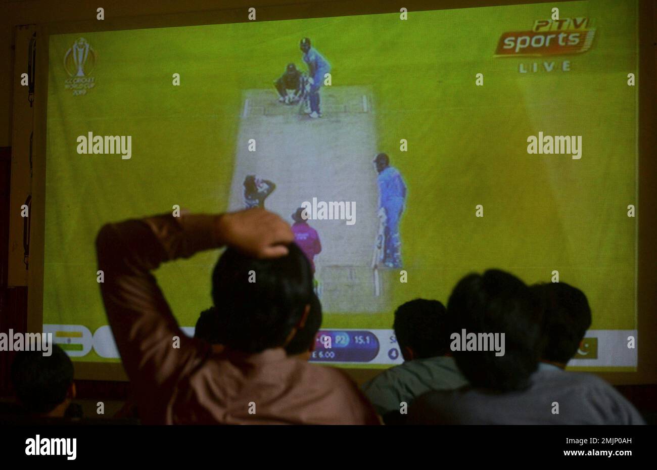 People watch the cricket World Cup match between Pakistan and India, on a big screen in Peshawar, Pakistan, Sunday, June 16, 2019