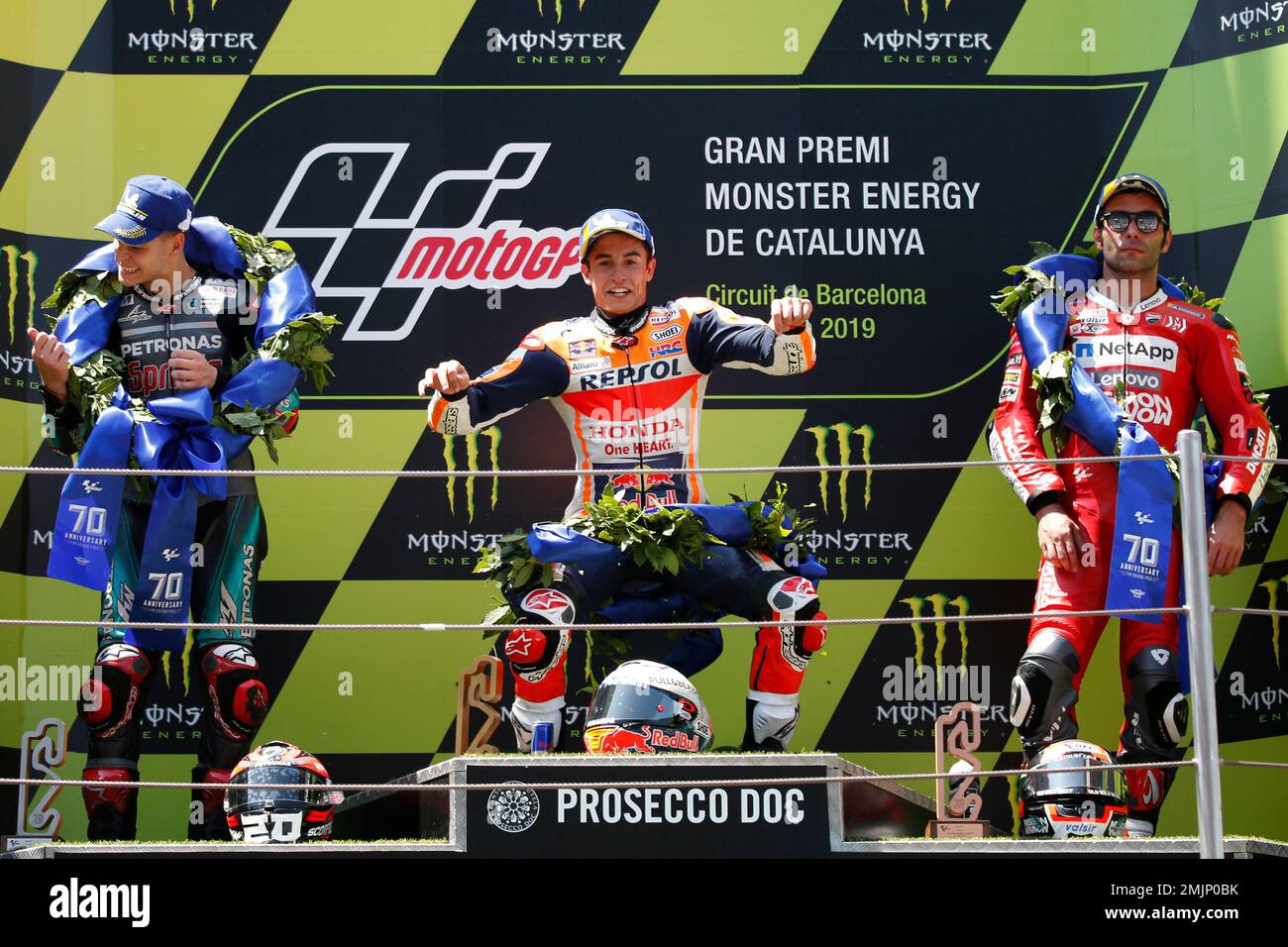 MotoGP Honda rider Marc Marquez of Spain, center, celebrates after winning  the Catalunya Motorcycle Grand Prix alongside 2nd placed Fabio Quartararo  of France, left and 3rd placed Danilo Petrucci of Italy at