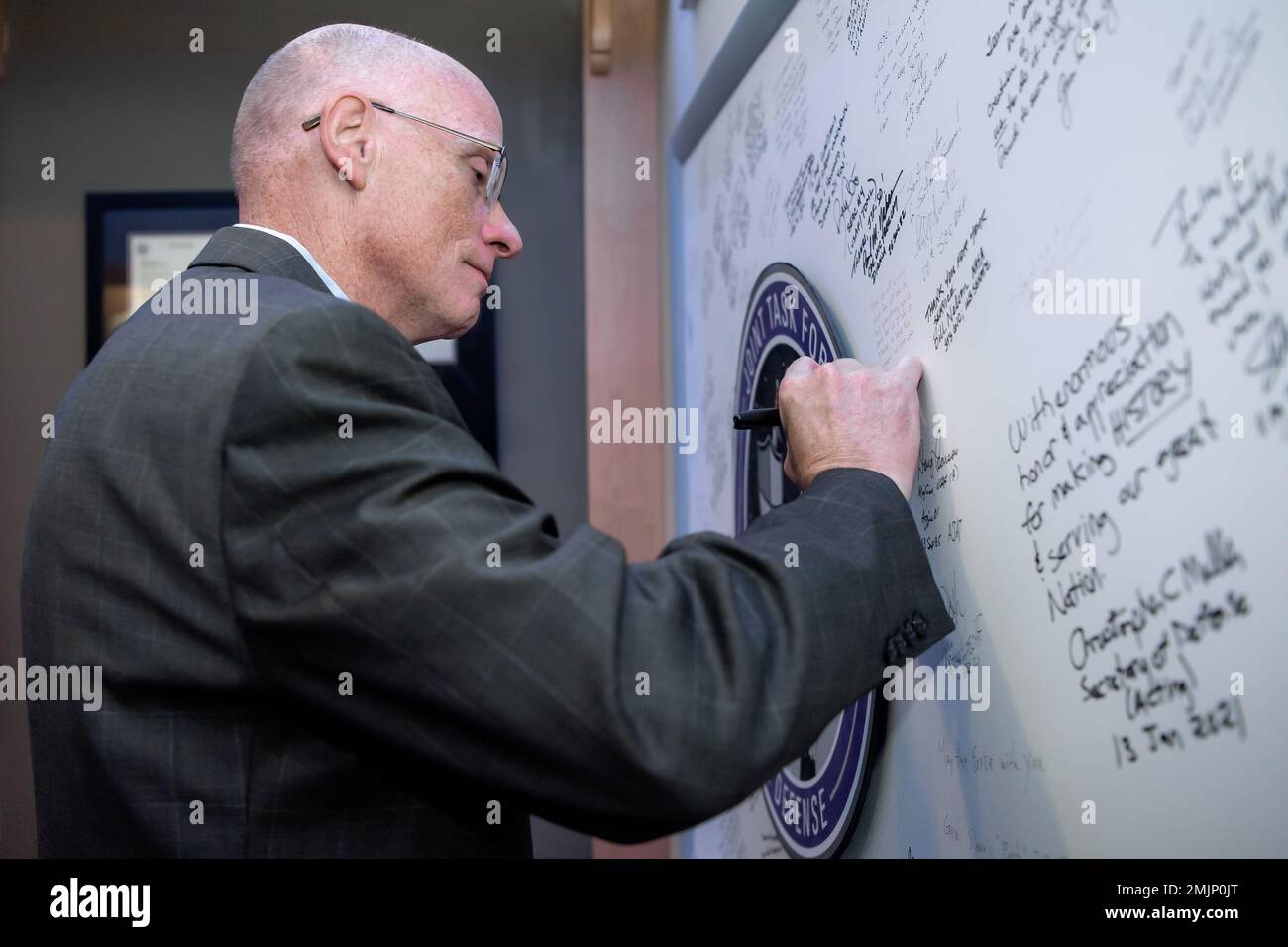 George C. Barnes, deputy director and senior civilian leader of the National Security Agency, signs the Joint Task Force-Space Defense’s board during his visit to the organization at Schriever Space Force Base, Colorado, Aug. 31, 2022. This marked Barnes' first visit to the JTF-SD and its National Space Defense Center. The JTF-SD, and its NSDC, provide unprecedented unity of effort with the Department of Defense, Intelligence Community and National Reconnaissance Office to protect and defend against threats in the space domain. Stock Photo