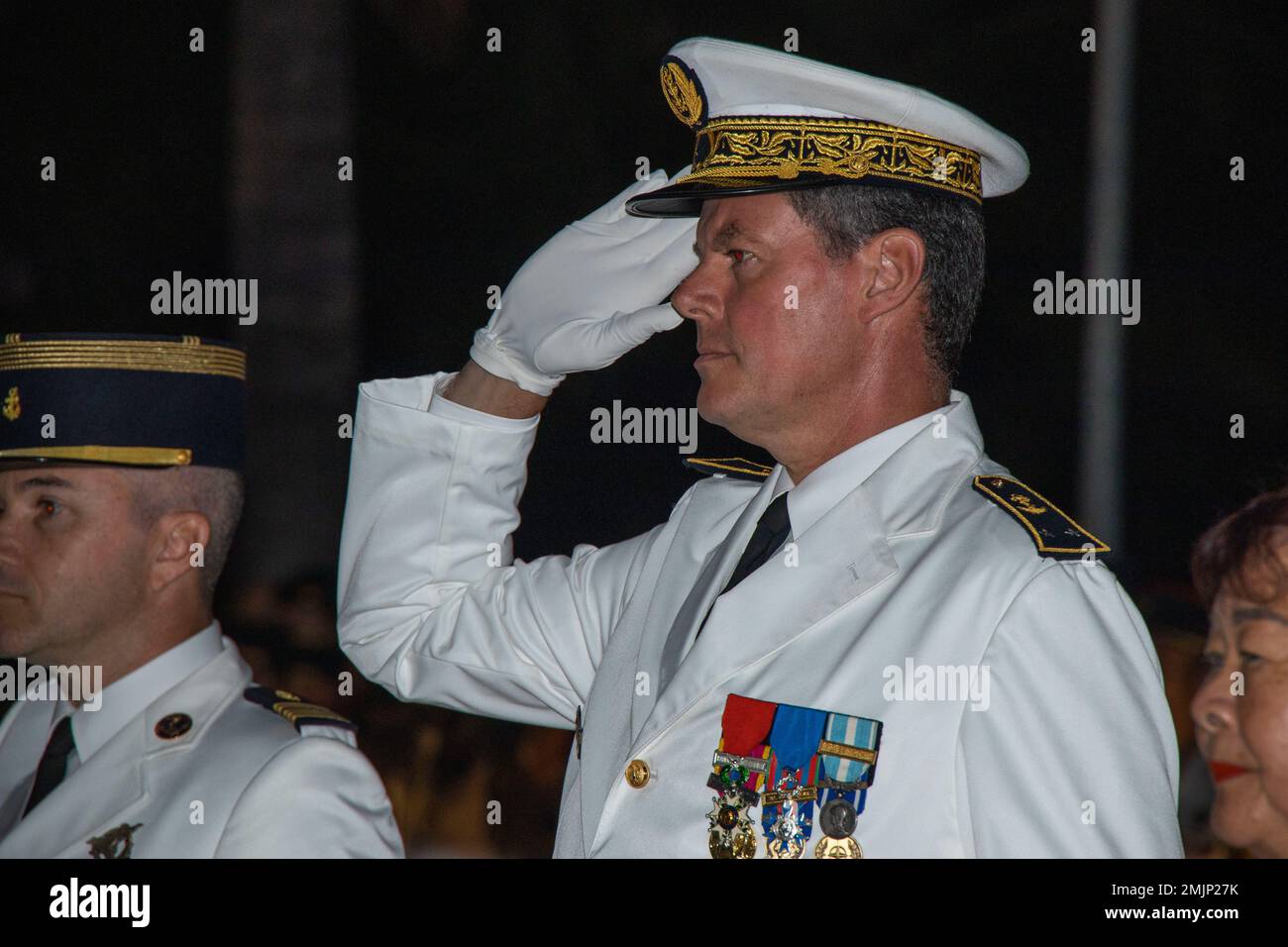 French Navy Rear Adm. Geoffroy d'Andigne, joint commander of the French Armed Forces in the Asia-Pacific, renders a salute during the playing of the French National Anthem during the Bazeilles Day Ceremony in Pirae, Tahiti, French Polynesia, Aug. 31, 2022. The ceremony honored the events of the Franco-Prussian War in 1870, when French Marines stood up to a force of Bavarians who outnumbered the French 10 to one. Taking place in the French Village of Bazeilles, the battle is considered one of the first occurrences of urban warfare. Stock Photo