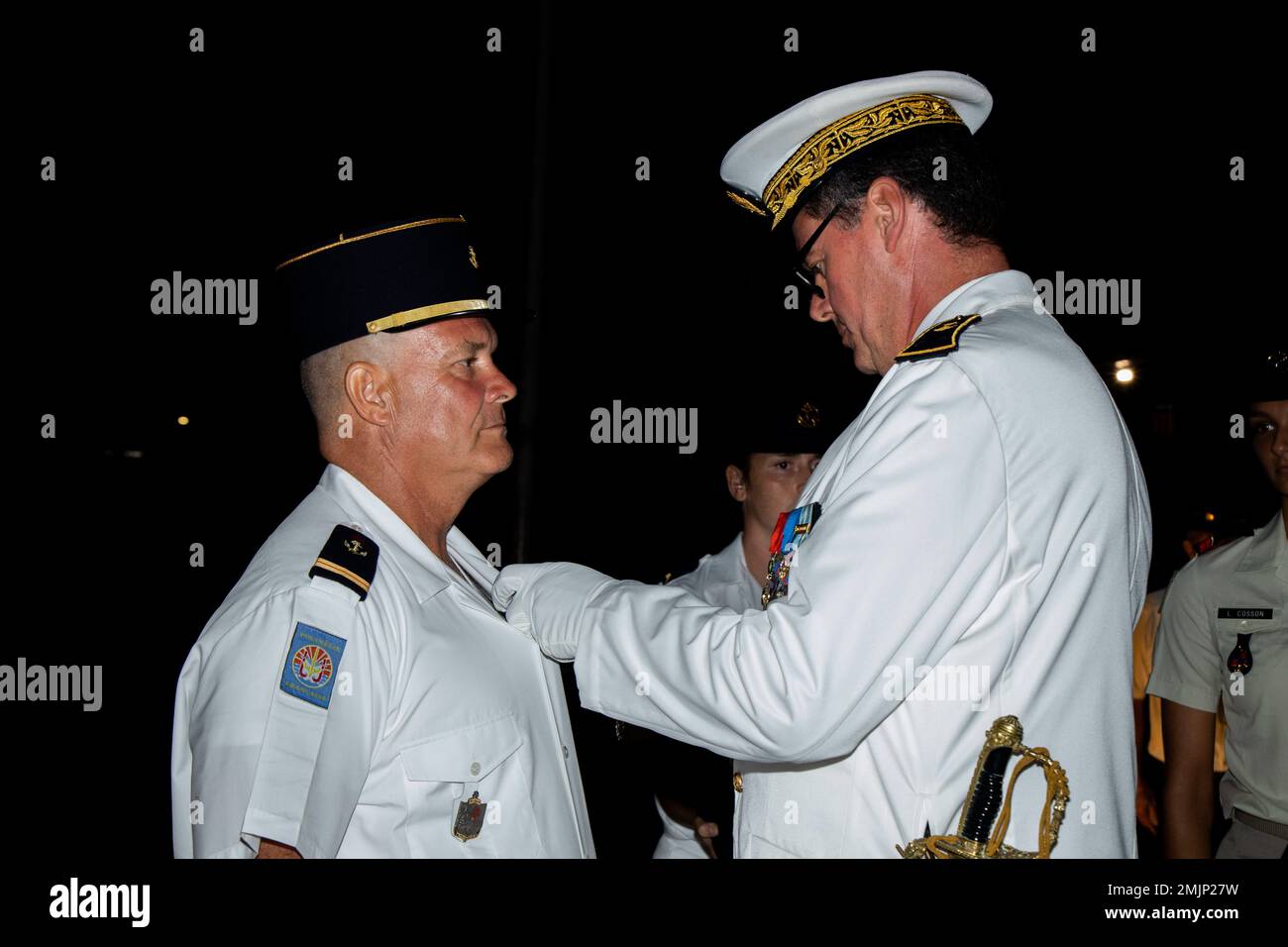 French Navy Rear Adm. Geoffroy d'Andigne, right, joint commander of the French Armed Forces in the Asia-Pacific, French Armed Forces in French Polynesia, awards the Medale Militaire to Adjutant-chef de la Gendarmerie Maritime Olivier Landes during the Bazeilles Day Ceremony in Arue, Tahiti, French Polynesia, Aug. 31, 2022. The ceremony honored the events of the Franco-Prussian War in 1870, when French Marines stood up to a force of Bavarians who outnumbered the French 10 to one. Taking place in the French Village of Bazeilles, the battle is considered one of the first occurrences of urban warf Stock Photo