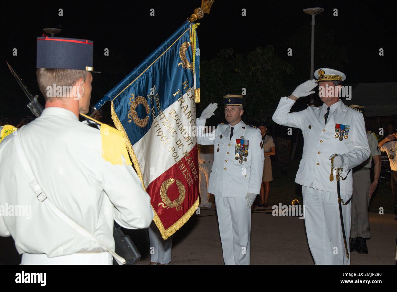 French Navy Rear Adm. Geoffroy d'Andigne, right, joint commander of the French Armed Forces in the Asia-Pacific, French Armed Forces in French Polynesia, renders a salute during the playing of the French National Anthem during the Bazeilles Day Ceremony in Pirae, Tahiti, French Polynesia, Aug. 31, 2022. The ceremony honored the events of the Franco-Prussian War in 1870, when French Marines stood up to a force of Bavarians who outnumbered the French 10 to one. Taking place in the French Village of Bazeilles, the battle is considered one of the first occurrences of urban warfare. Stock Photo