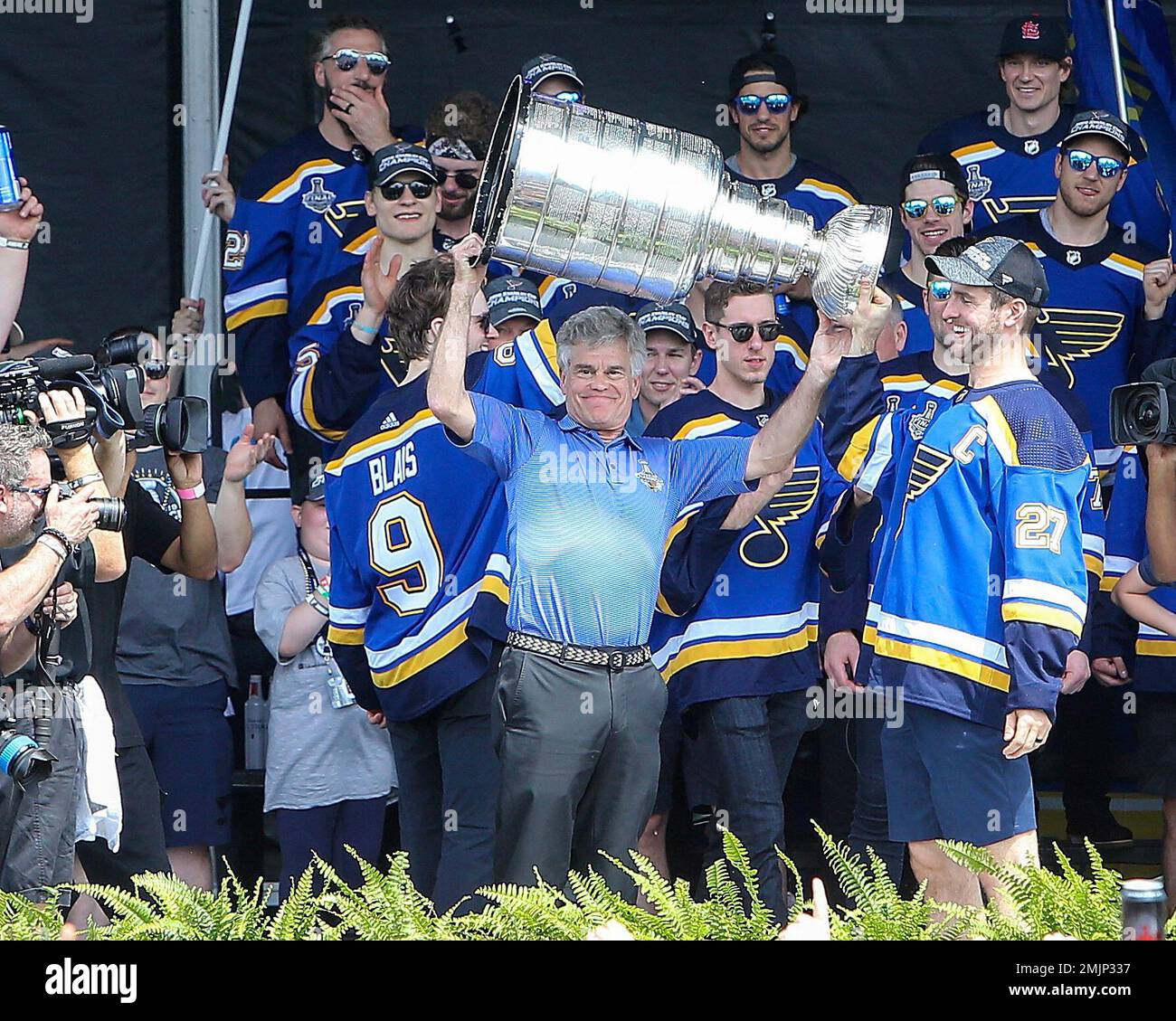 St. Louis Blues Chairman Tom Stillman (R) and St. Louis Cardinals President  Bill DeWitt III prepare for a ceremonial puck drop before the St. Louis  Blues-Carolina Hurricanes hockey game at the Scottrade