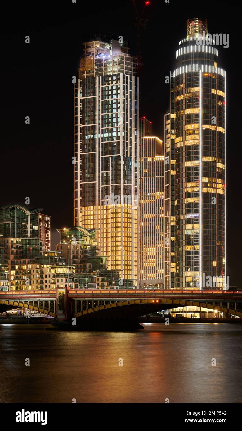 Nightime skyline of riverside skyscrapers beside the bridge at Vauxhall over the river Thames, London, England. Stock Photo