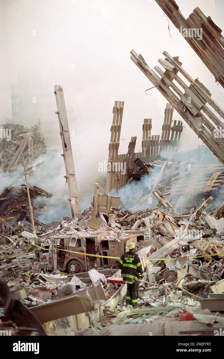 A lone FDNY Battalion Chief guards the remains of a fire engine as he ...