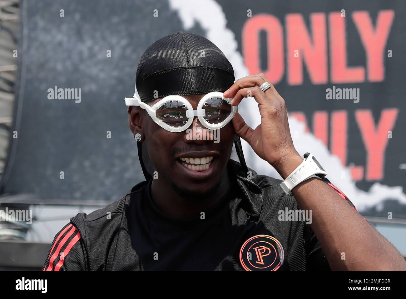 Manchester United's soccer player Paul Pogba, adjusts his goggles, given by  a fan, during a meeting with his fans following a media day in Seoul, South  Korea, Thursday, June 13, 2019. Pogba