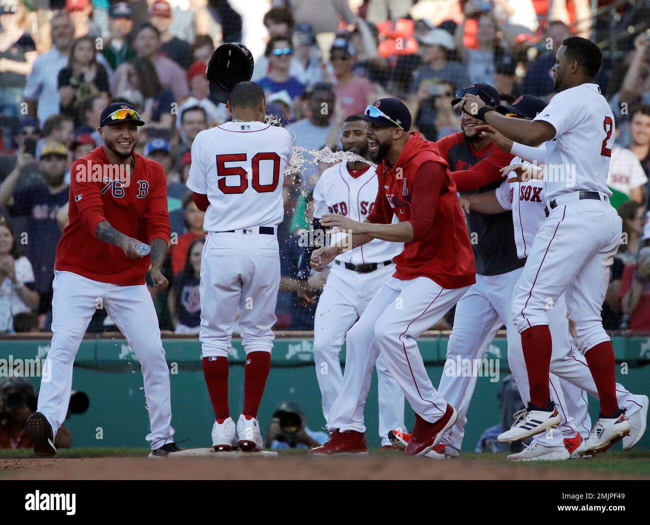 Boston Red Sox's Mookie Betts (50) is doused by teammates after
