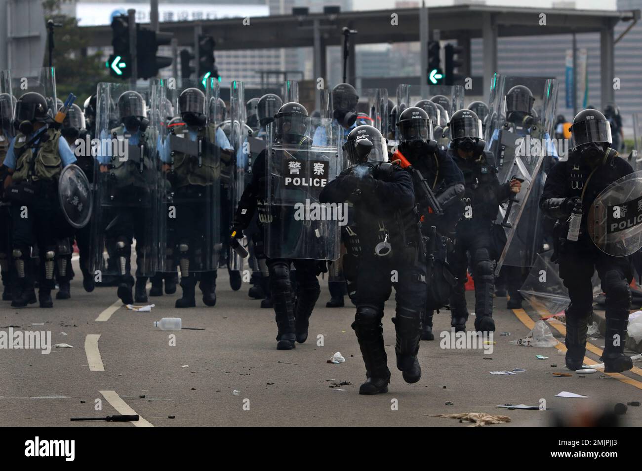 Riot police fire toward thousands of protesters who had massed outside ...