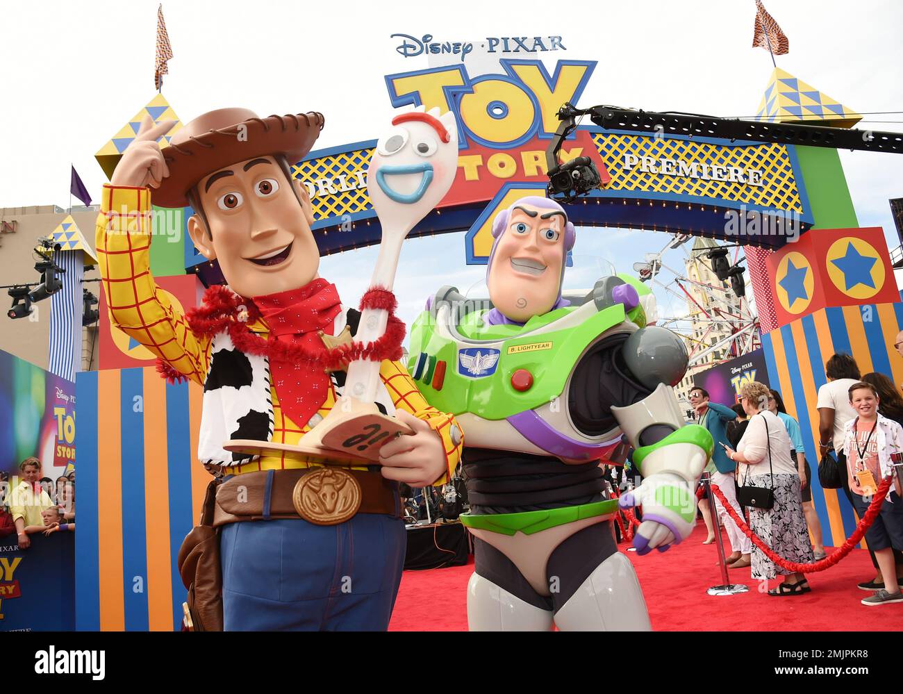 Characters Woody, left, and Buzz Lightyear pose together at the premiere of the film "Toy Story
