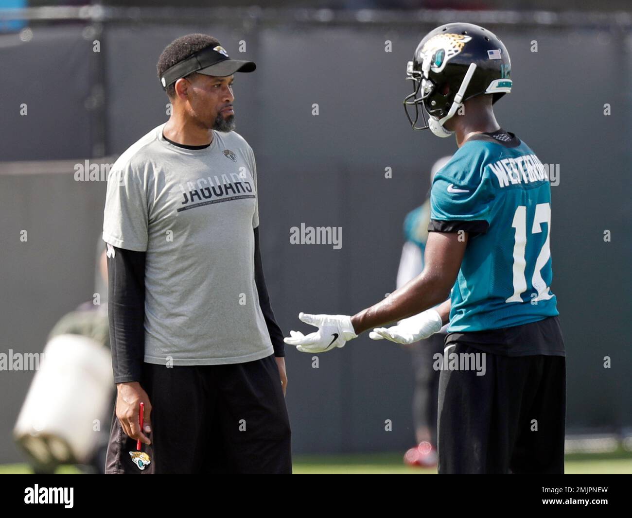 Jacksonville Jaguars wide receivers coach Keenan McCardell, left, talks