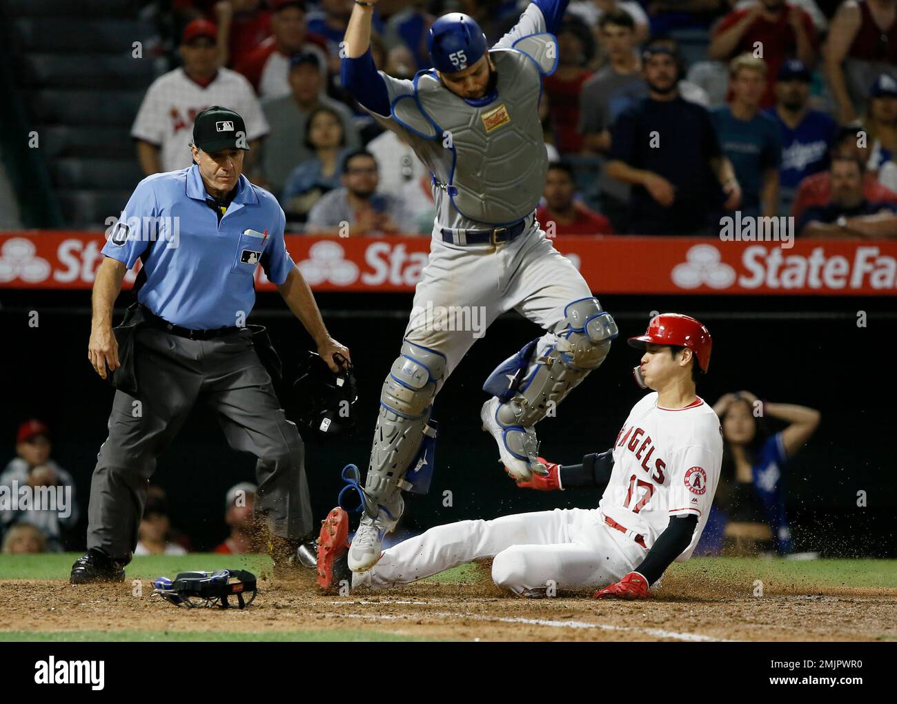 Los Angeles Angels' Shohei Ohtani, right, slides in safely to touch
