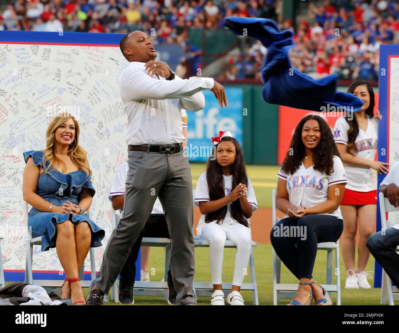 Retired player Adrian Beltre, jokingly tosses a robe gifted to him by