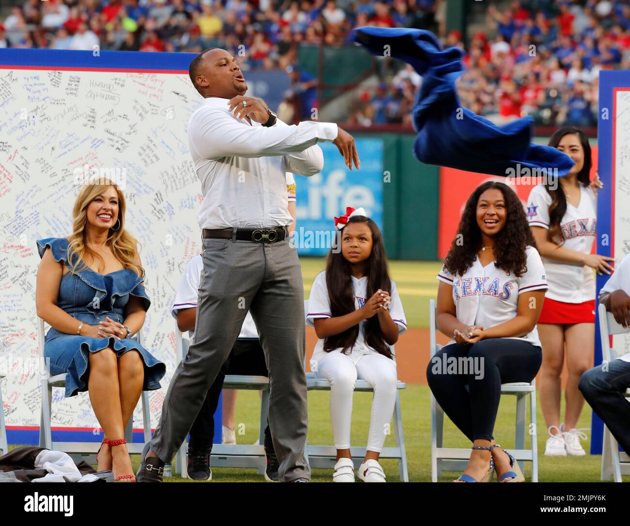 Retired player Adrian Beltre, jokingly tosses a robe gifted to him