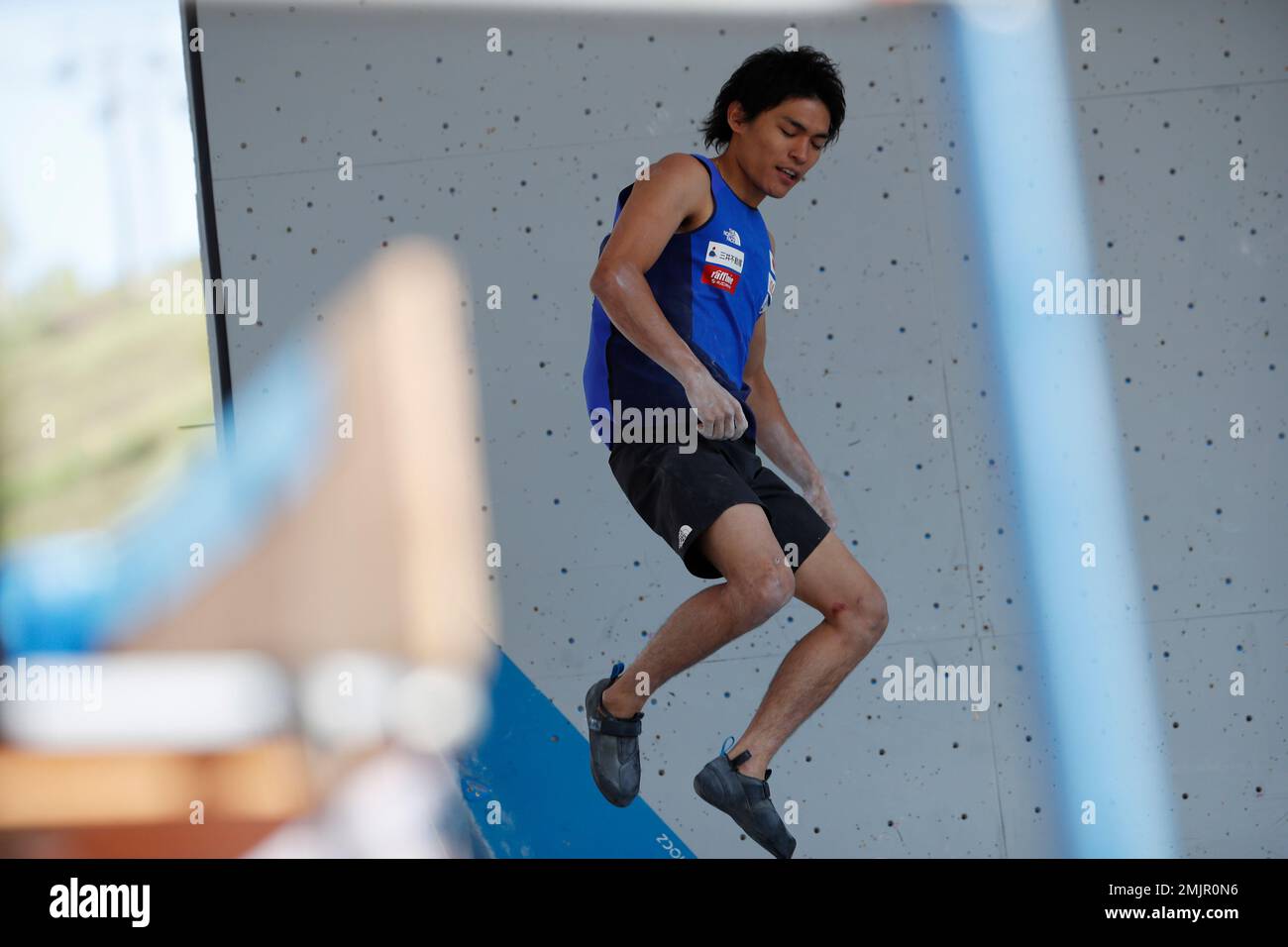 Tomoa Narasaki of Japan jumps down after finishing a wall during the