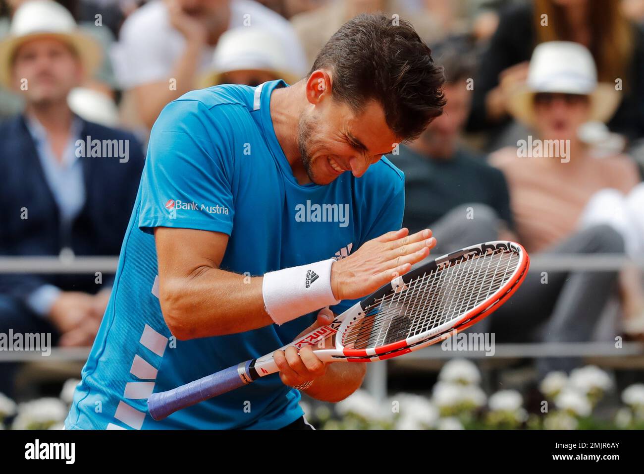 Austria's Dominic Thiem hits his racket after hitting a shot into the net  in the second set against Spain's Rafael Nadal during the men's final match  of the French Open tennis tournament