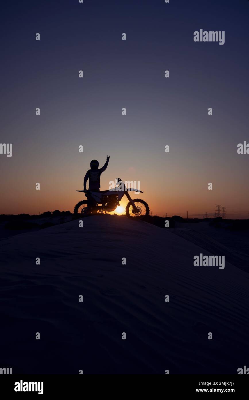 Motorcycle, success and person silhouette celebrating victory against a night, sky and background in nature. Sports, motorbike and biker stop for Stock Photo