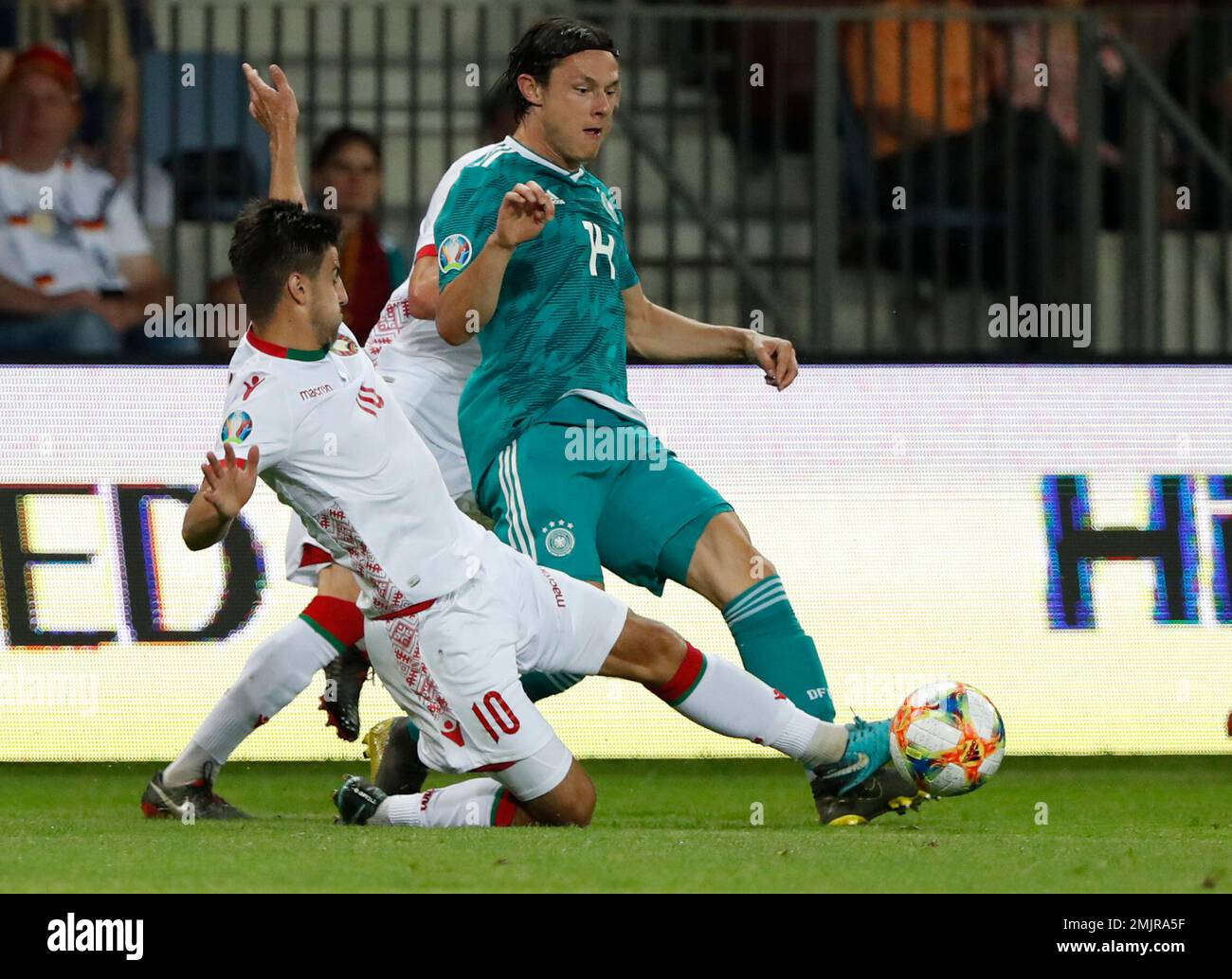 Belarus' Valeri Gromyko, left, vies for the ball with Germany's Nico Schulz during the Euro 2020 group C qualifying soccer match between Belarus and Germany at the Borisov-Arena in Borisov, Belarus, Saturday, June 8, 2019. (AP Photo/Mindaugas Kulbis) Stock Photo