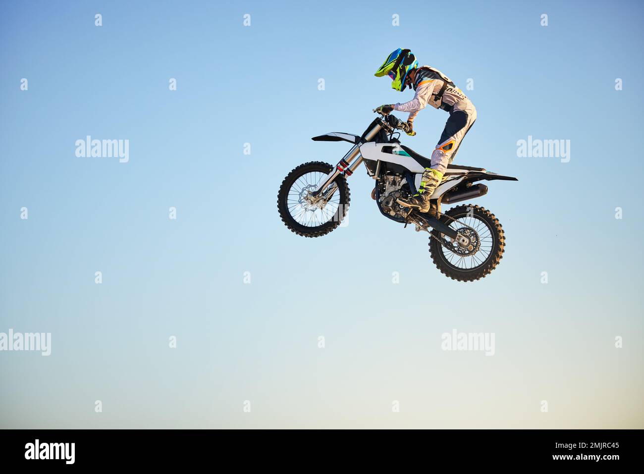 Motorbike, jump and person on blue sky mockup for training, competition ...