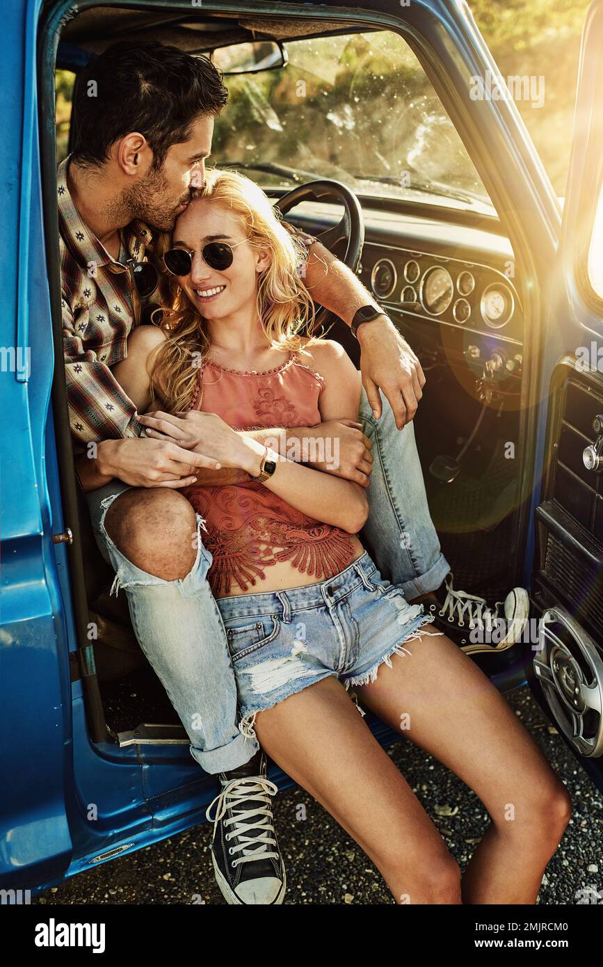 Each passing mile brings them closer together. a young couple out on a road trip with their truck. Stock Photo
