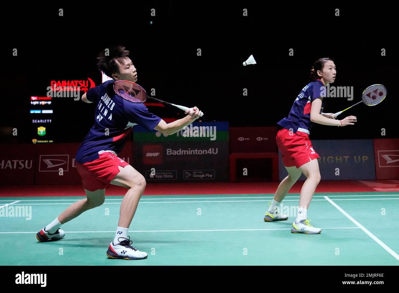 Chinas Jiang Zhen Bang, left, with Wei Ya Xin, plays a shot to Japans Misaki Matsutomo and Yuki Kaneko during their semifinal mixed doubles match in the Indonesia Masters badminton tournament at