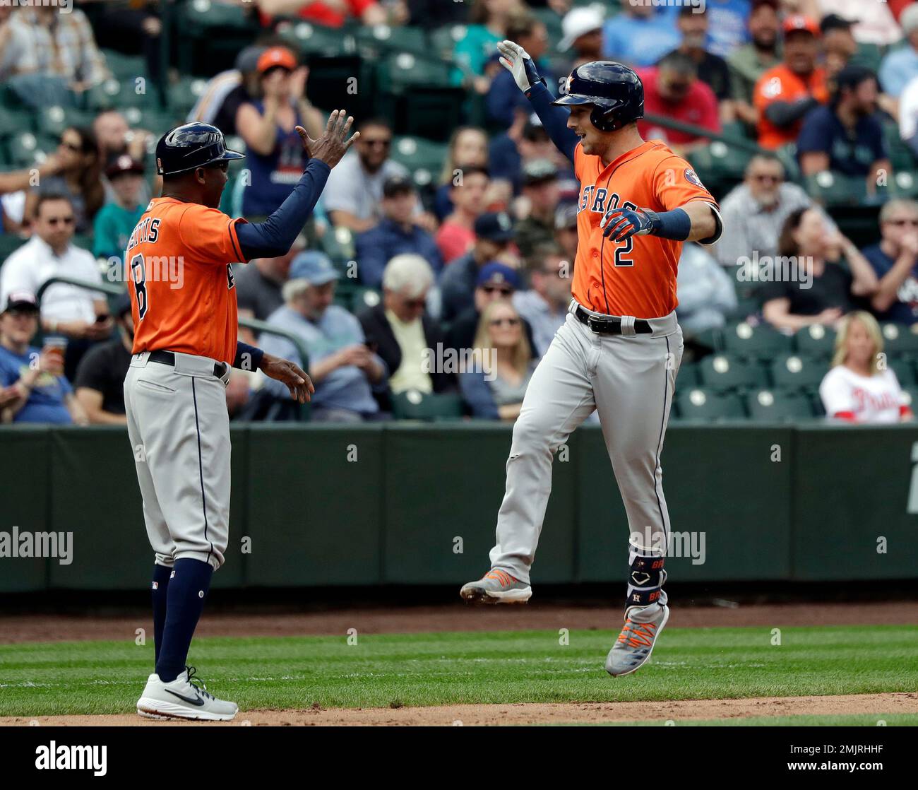 Houston Astros' Alex Bregman (2) leaps to high five third base coach Gary  Pettis on his solo home run against the Seattle Mariners in the fifth  inning of a baseball game Thursday,